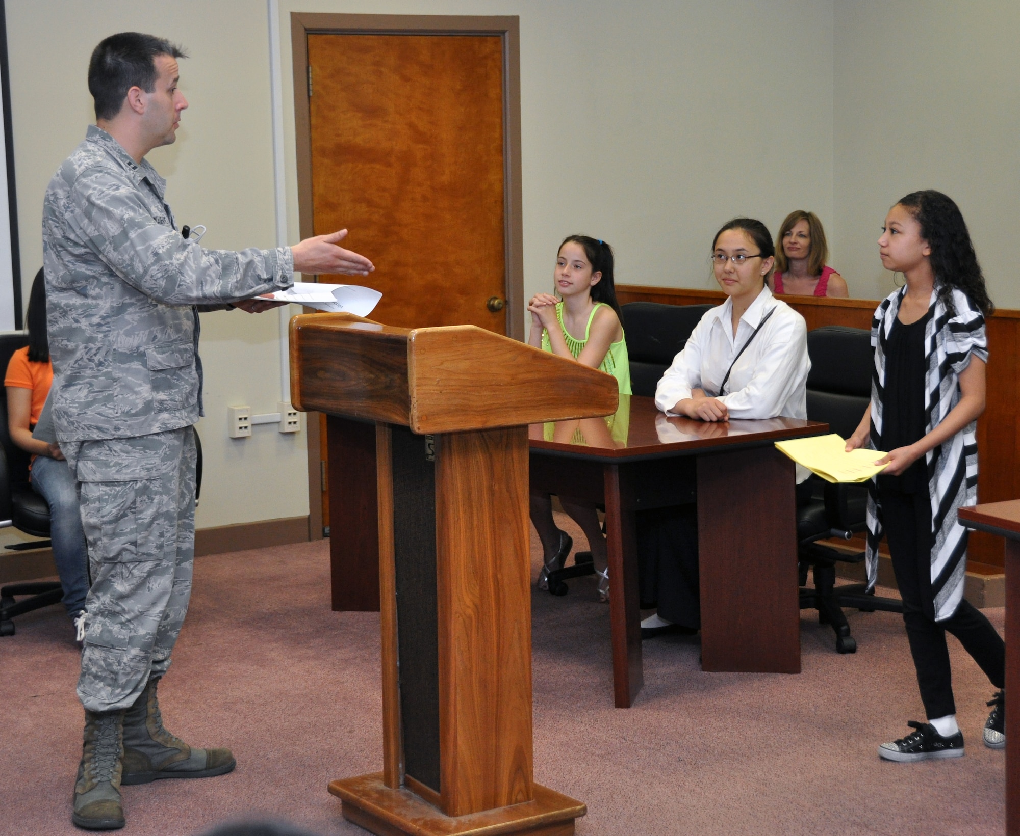 Capt. Matthew Ramage-White, 51st Fighter Wing assistant judge advocate, explains the mock trial scenario “The stolen car” to students of Osan Middle School during Law Day at Osan Air Base, Republic of Korea, May 1, 2012. Every year, legal officials have used Law Day as an opportunity to educate the community on the legal system, courtroom and how the law is used to protect Constitutional rights. (U.S. Air Force photo/Airman 1st Class Michael Battles)