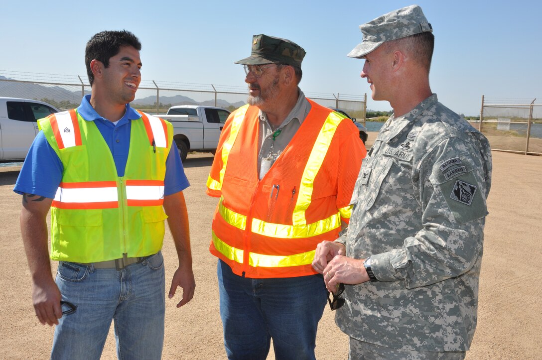 David Rodriguez (left) speaks with Louis "Dutch" Bonnet and Col. Mike Wehr, U.S. Army Corps of Engineers South Pacific Division commander (who has since been promoted to Brig. Gen. since the time this image was taken) during Wehr's visit in November 2011 to the Tres Rios Ecosystem Restoration Project in Phoenix. Rodriguez recently received a commission as an Ensign in the U.S. Navy Reserves. 