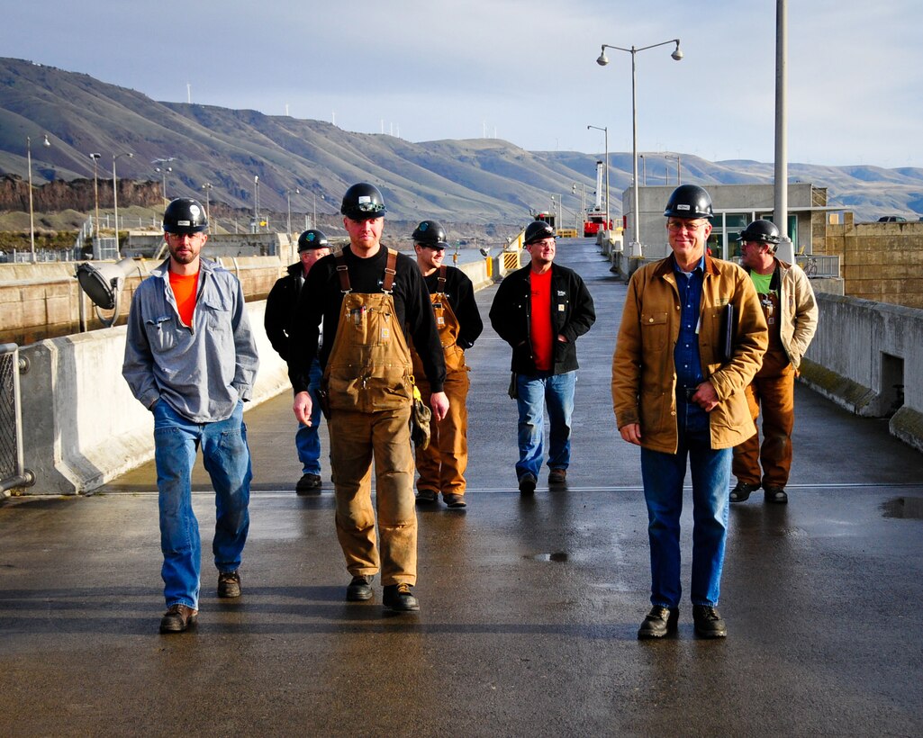 Workers stride out to begin another long day. Progress continues as John Day gate sections are moved into place following the dewatering, which began Dec. 10, 2010.