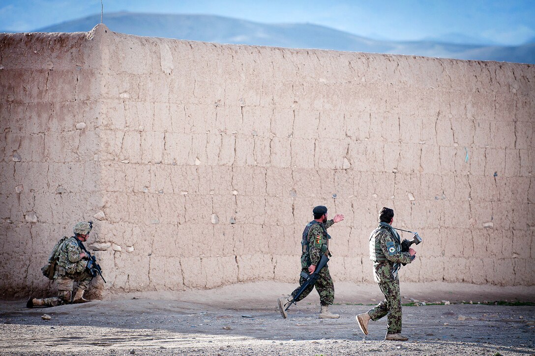 U.S. Army Spc. Jason Castaneda pulls security as two Afghan soldiers move from building to building during a combined patrol clearing operation in Afghanistan's Ghazni province, April 28, 2012. Castaneda is assigned to the 82nd Airborne Division’s 2nd Battalion, 504th Parachute Infantry Regiment, 1st Brigade Combat Team.