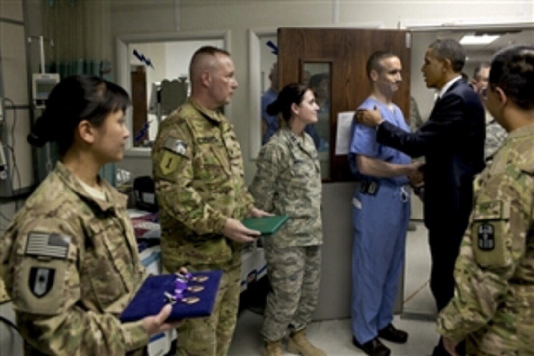 President Barack Obama greets hospital personnel in the ICU at Bagram Airfield, Afghanistan, May 1, 2012. Obama presented 10 Purple Hearts, three in the ICU. Obama met with troops after announcing he had signed a strategic partnership agreement with Afghan President Hamid Karzai detailing the relationship between the United States and Afghanistan as the war there nears an end. 