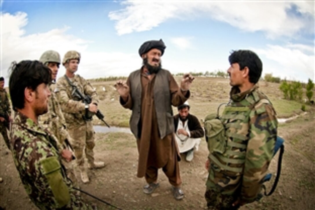 U.S. Army 1st Lt. Timothy Harting stands by as an Afghan soldier questions a villager about the presence of insurgents in the area during a combined patrol in Afghanistan's Ghazni province, April 28, 2012. Harting, a platoon leader, is assigned to the 82nd Airborne Division’s 2nd Battalion, 504th Parachute Infantry Regiment, 1st Brigade Combat Team.