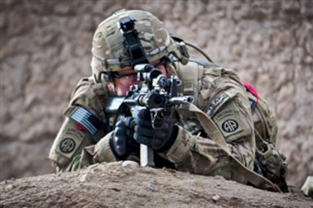 A U.S. paratrooper uses his weapon's scope to scan the area while pulling security during a combined patrol in Afghanistan's Ghazni province, April 28, 2012.