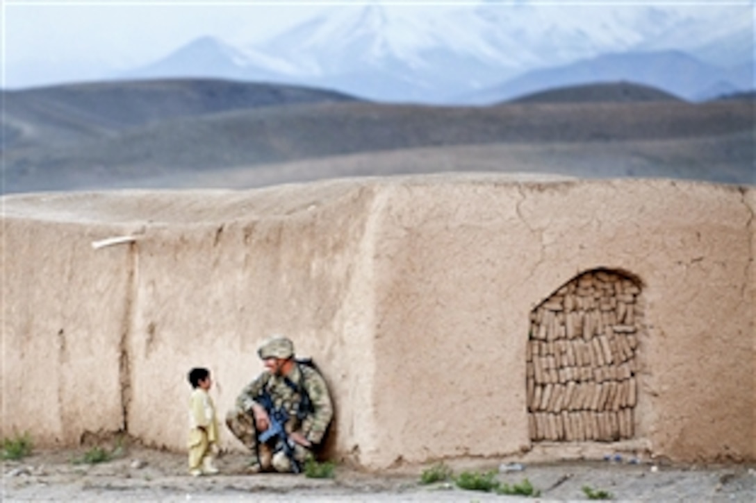 U.S. Army Sgt. Joshua Smith chats with an Afghan boy during a combined patrol clearing operation in Afghanistan's Ghazni province, April 28, 2012. Smith is assigned to the 82nd Airborne Division’s 2nd Battalion, 504th Parachute Infantry Regiment, 1st Brigade Combat Team.