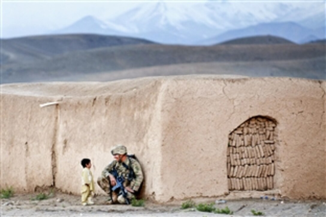 U.S. Army Sgt. Joshua Smith chats with an Afghan boy during a combined patrol clearing operation in Afghanistan's Ghazni province, April 28, 2012. Smith is assigned to the 82nd Airborne Division’s 2nd Battalion, 504th Parachute Infantry Regiment, 1st Brigade Combat Team.