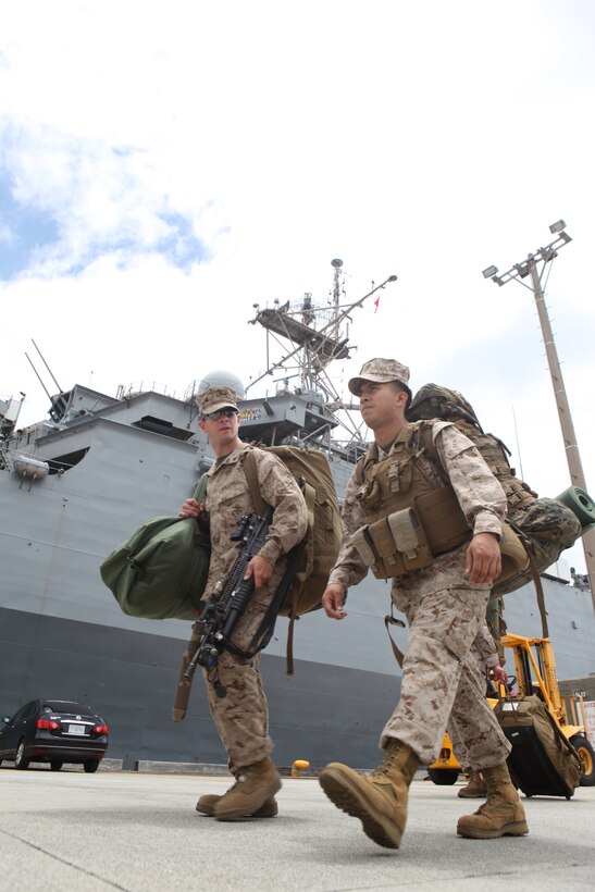 Sgt. Louis Vasquez (right), chief cook with Headquarters and Service Company, Battalion Landing Team 1st Battalion, 4th Marines, 31st Marine Expeditionary Unit, walks with Lance Cpl. Andrew Cunningham, team leader with Company C., BLT 1/4, after disembarking from the USS Denver (LPD-9) here following the month-long bilateral training Exercise Balikatan in the Philippines, May 3. Balikatan, (shoulder-to-shoulder in English) is the last training evolution 1/4 will take part in before detaching from the 31st MEU and returning to their home garrison on Marine Corps Base Camp Pendleton. The 31st MEU is the only continuously forward-deployed MEU and remains the nation’s::r::::n::force in readiness in the Asia-Pacific region.