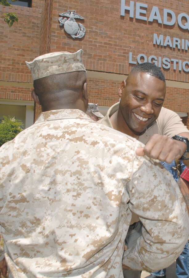 Master Sgt. Freddie M. Hill Jr. receives a handshake from a Marine after being deployed to Afghanistan for six months.
