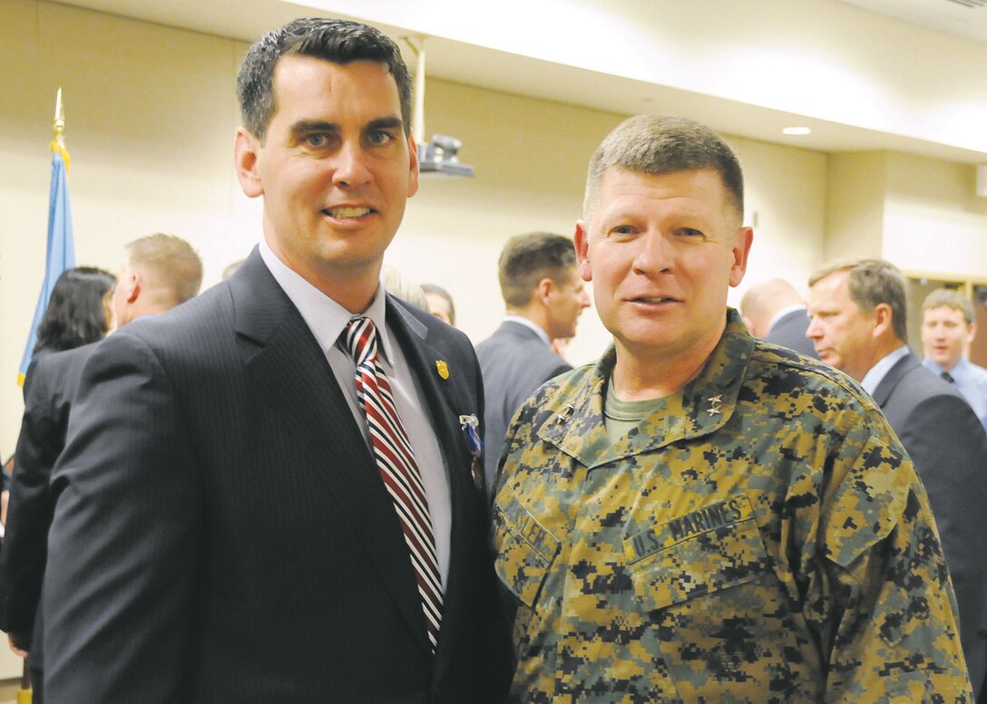 Rick Dunwoodie, Naval Criminal Investigative Service special agent, poses with Maj. Gen. James A. Kessler, commander, Marine Corps Installations Command/Assistant Deputy Commandant for Installations and Logistics (Facilities) and former commanding general, Marine Corps Logistics Command, at a recent NCIS awards ceremony.
