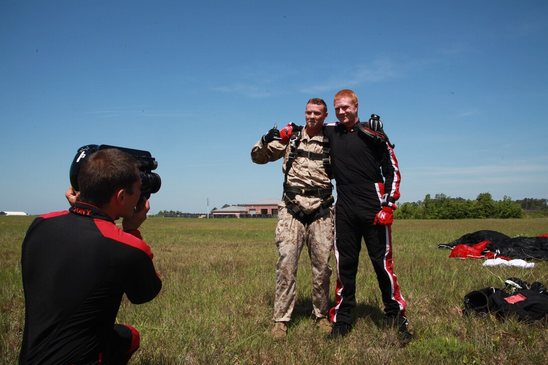 Army Sgt. Jeff Inman, a demonstration parachutist with the United States Army Special Operations Command, Black Daggers and Cpl. Kevin Willis, an aircraft electronic countermeasures technician with Marine Tactical Electronic Warfare Squadron 4, pose for a photo after completing their tandem skydive May 3. The service members jumped from approximately 10,000 feet.