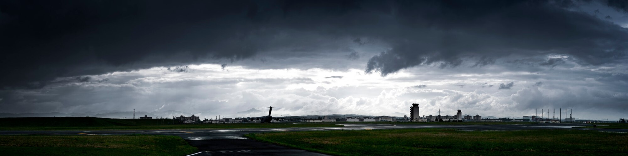YOKOTA AIR BASE, Japan -- Thick clouds drift by the flightline at Yokota Air Base, Japan, May 1, 2012. Surrounded by water, the average relative humidity in Japan is 71.2 percent according to www.climatetemp.info, almost 20 percentage points higher than the U.S. average. (U.S. Air Force photo illustration/Staff Sgt. Samuel Morse)