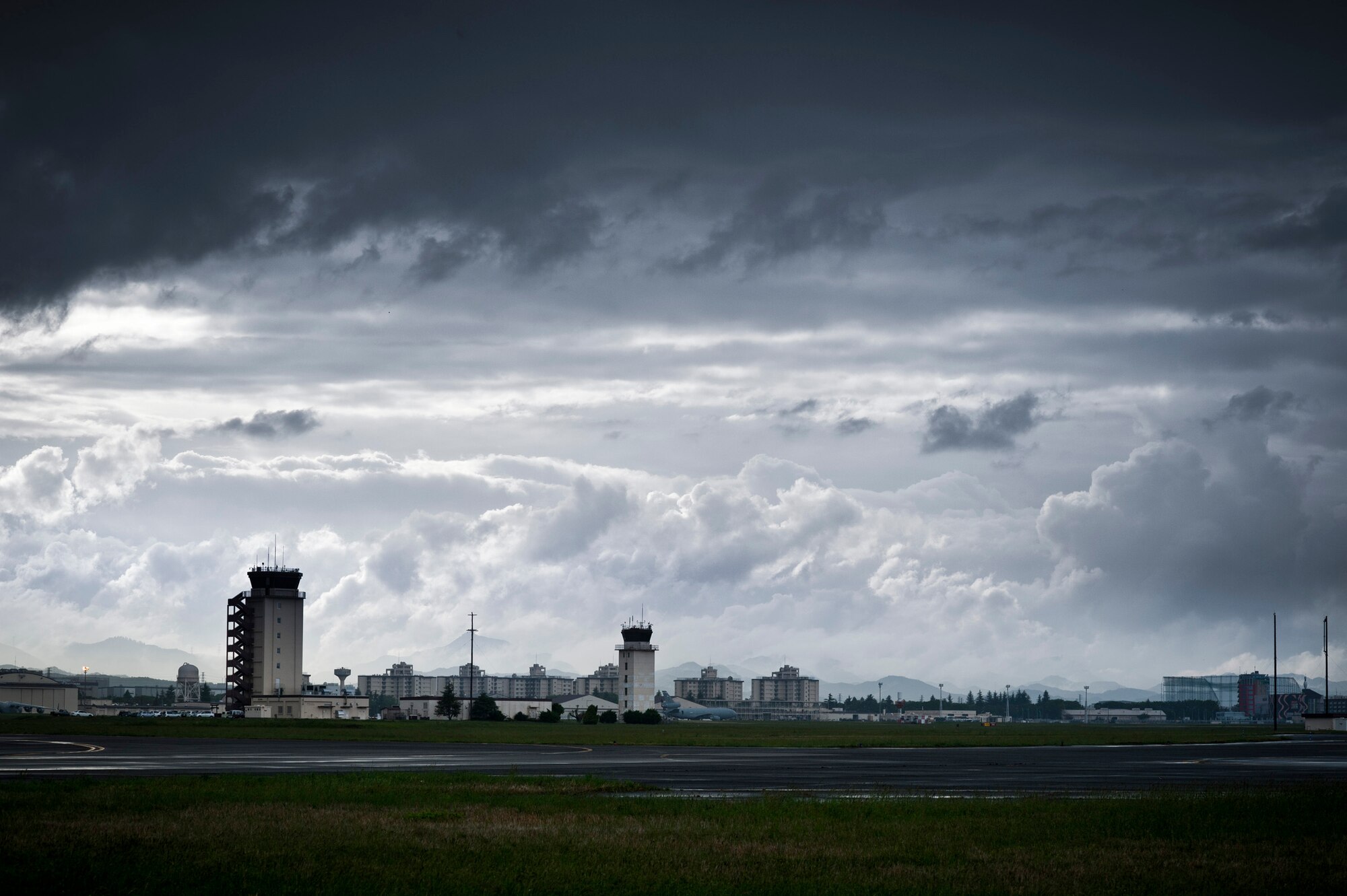 YOKOTA AIR BASE, Japan -- Thick clouds drift by the flightline at Yokota Air Base, Japan, May 1, 2012. Surrounded by water, the average relative humidity in Japan is 71.2 percent according to www.climatetemp.info, almost 20 percentage points higher than the U.S. average. (U.S. Air Force photo illustration/Staff Sgt. Samuel Morse)