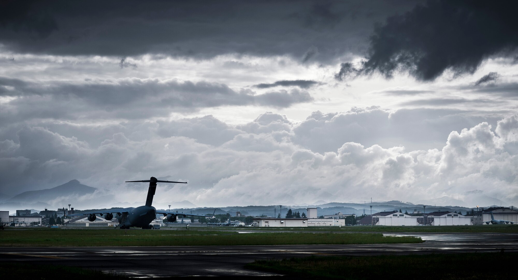YOKOTA AIR BASE, Japan -- Thick clouds drift by the flightline at Yokota Air Base, Japan, May 1, 2012. Surrounded by water, the average relative humidity in Japan is 71.2 percent according to www.climatetemp.info, almost 20 percentage points higher than the U.S. average. (U.S. Air Force photo illustration/Staff Sgt. Samuel Morse)