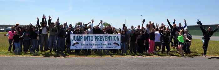 Members of Team Beale celebrate the conclusion of Beale’s Jump Into Prevention event at Lincoln Regional Airport, Calif., April 27, 2012. The skydiving event was put on by Beale’s Sexual Assault Prevention and Response Program to raise awareness about sexual assault.