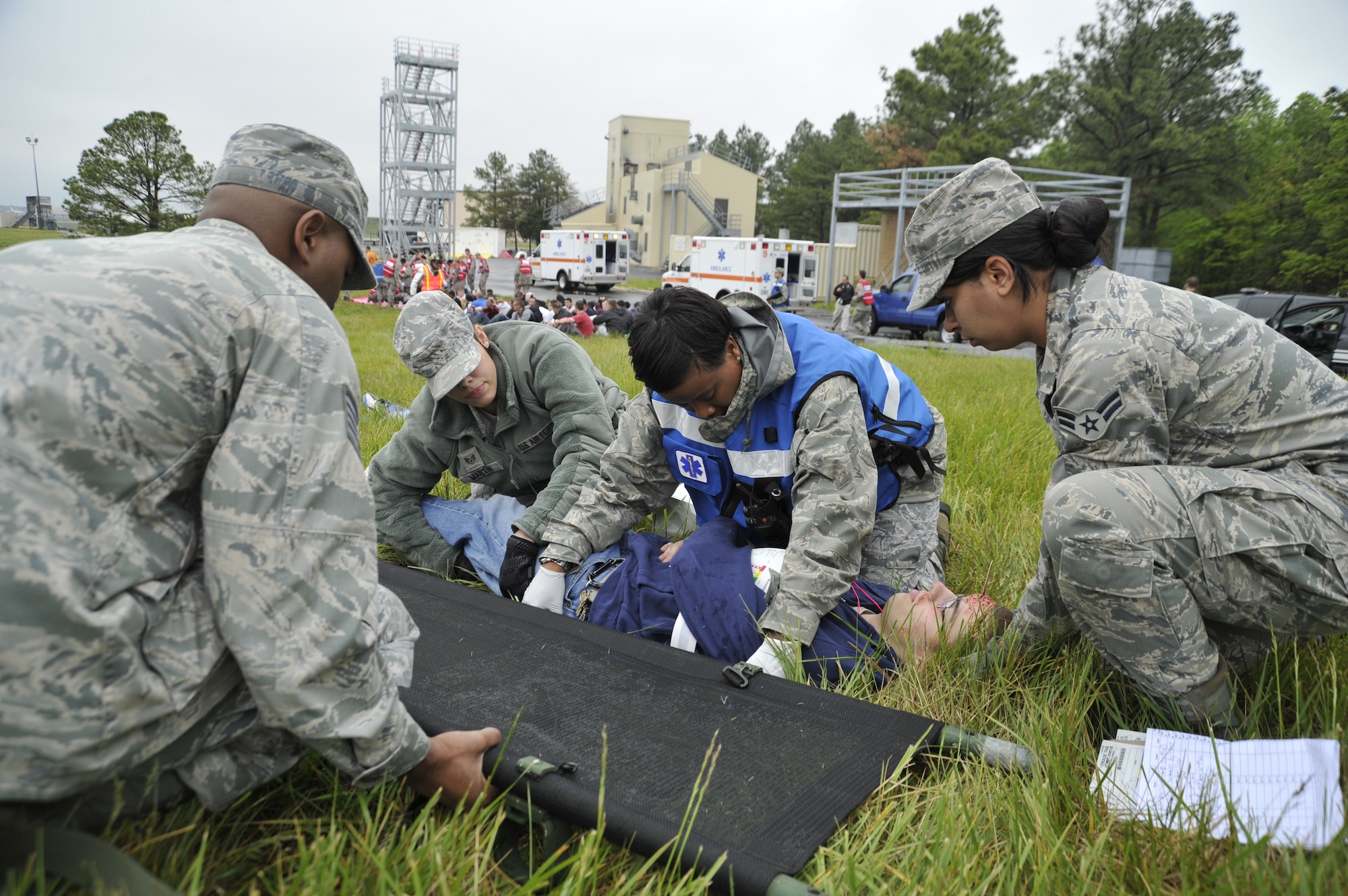 Medics from the 79th Medical Wing roll a simulated patient onto a litter during Exercise Sysyphus on April 26. Simulated patients and casualties helped prepare those involved in the exercise in case of a possible incident at the upcoming Andrews Joint Service Open House and Air Show. (U.S. Air Force photo/Senior Airman Perry Aston)