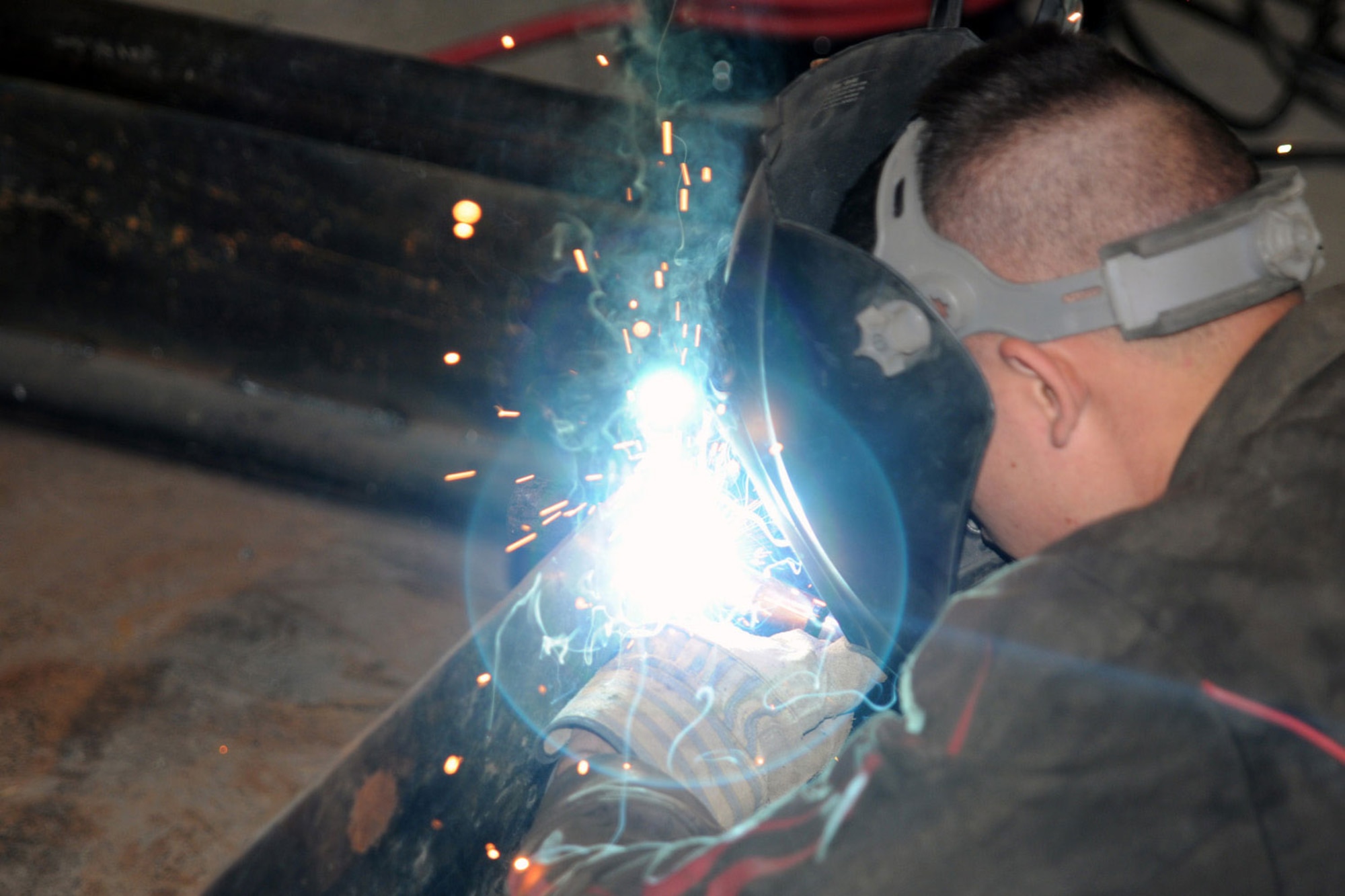 Pfc. Jacob Edgell, with the Weld Shop for B Company, 725th Brigade Support Battalion, and a native of Fallsburg, Ohio, welds a wheel mount for a spare tire onto a trailer April 25 at Forward Operating Base Salerno. (U.S. Army photo/Sgt. William Begley)