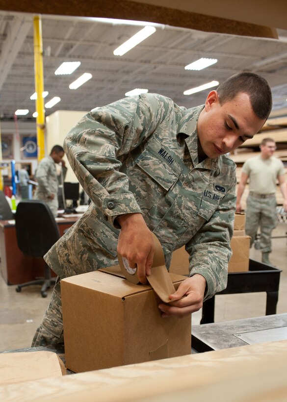 Airman Brandon Walsh, 28th Logistics Readiness Squadron packing and crating technician, seals a box of aircraft parts prior to being shipped at Ellsworth Air Force Base, S.D., May 1, 2012. The 28th LRS packing and crating section has shipped more than 12,000 packages since January. (U.S. Air Force photo by Airman 1st Class Alystria Maurer/Released)