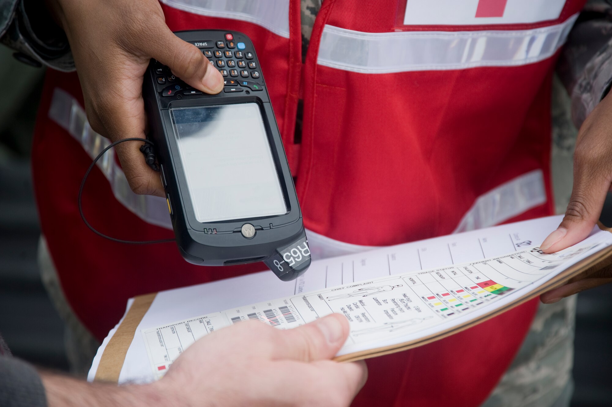 A 779th Medical Operation Squadron health services technician, uses a digital tracking device to scan patient information for accountability prior to releasing them to the first aid station during a mass casualty exercise on Andrews on April 26. (Photo/Bobby Jones) 
