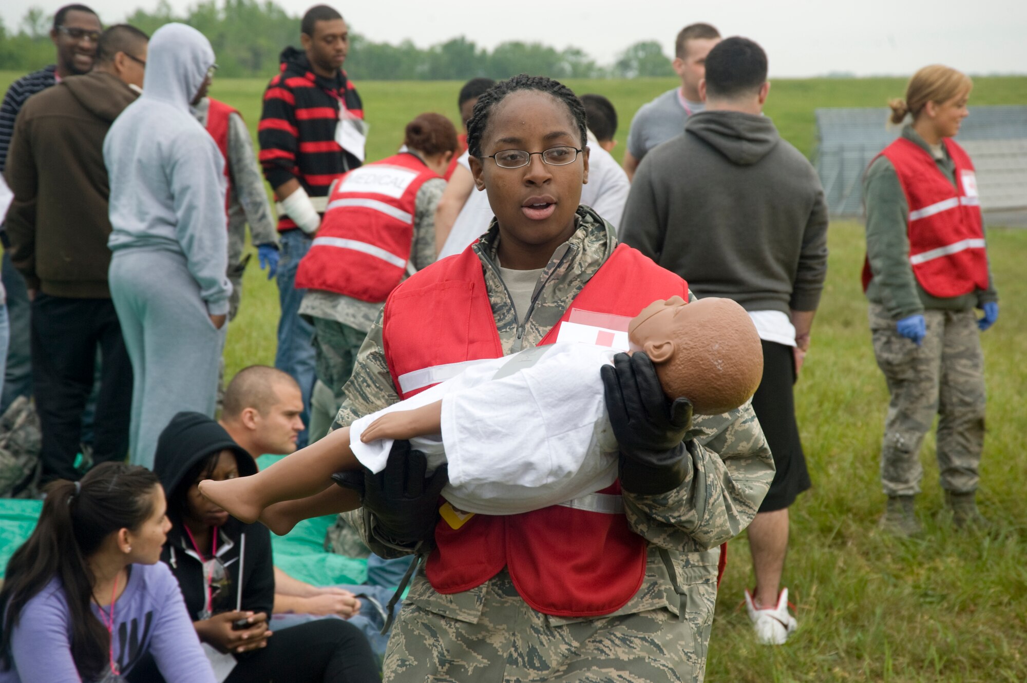 Airman 1st Class Jazmine Thomas, 779th Medical Operations Squadron medical technician, simulates consoling a crying infant separated from his parents during a mass casualty exercise here April 26.  (Photo/Bobby Jones) 