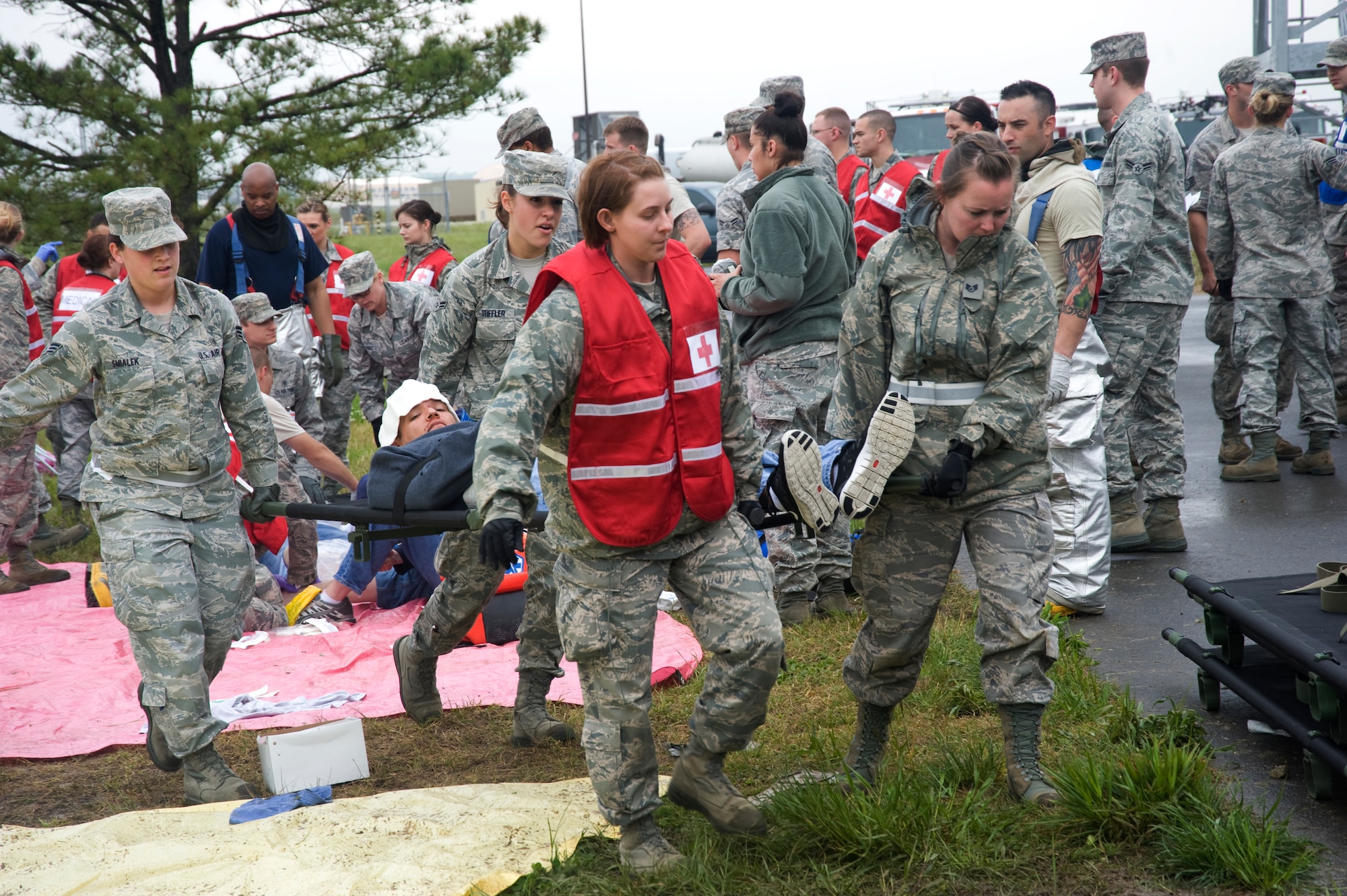 79th Medical Wing medical members transport a simulated injured patient by litter to a first aid station prior to transport to a local community hospital during a mass casualty exercise held on Joint Base Andrews April 26.  (Photo/Bobby Jones) 