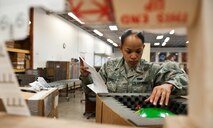 Airman 1st Class Tina Eversole, 28th Logistics Readiness Squadron packing and crating technician, compares a shipping label with the contents of a package during packing at Ellsworth Air Force Base, S.D., May 1, 2012. The 28th LRS packing and crating section is responsible for the shipment of all cargo to and from Ellsworth. (U.S. Air Force photo by Airman 1st Class Alystria Maurer/Released)