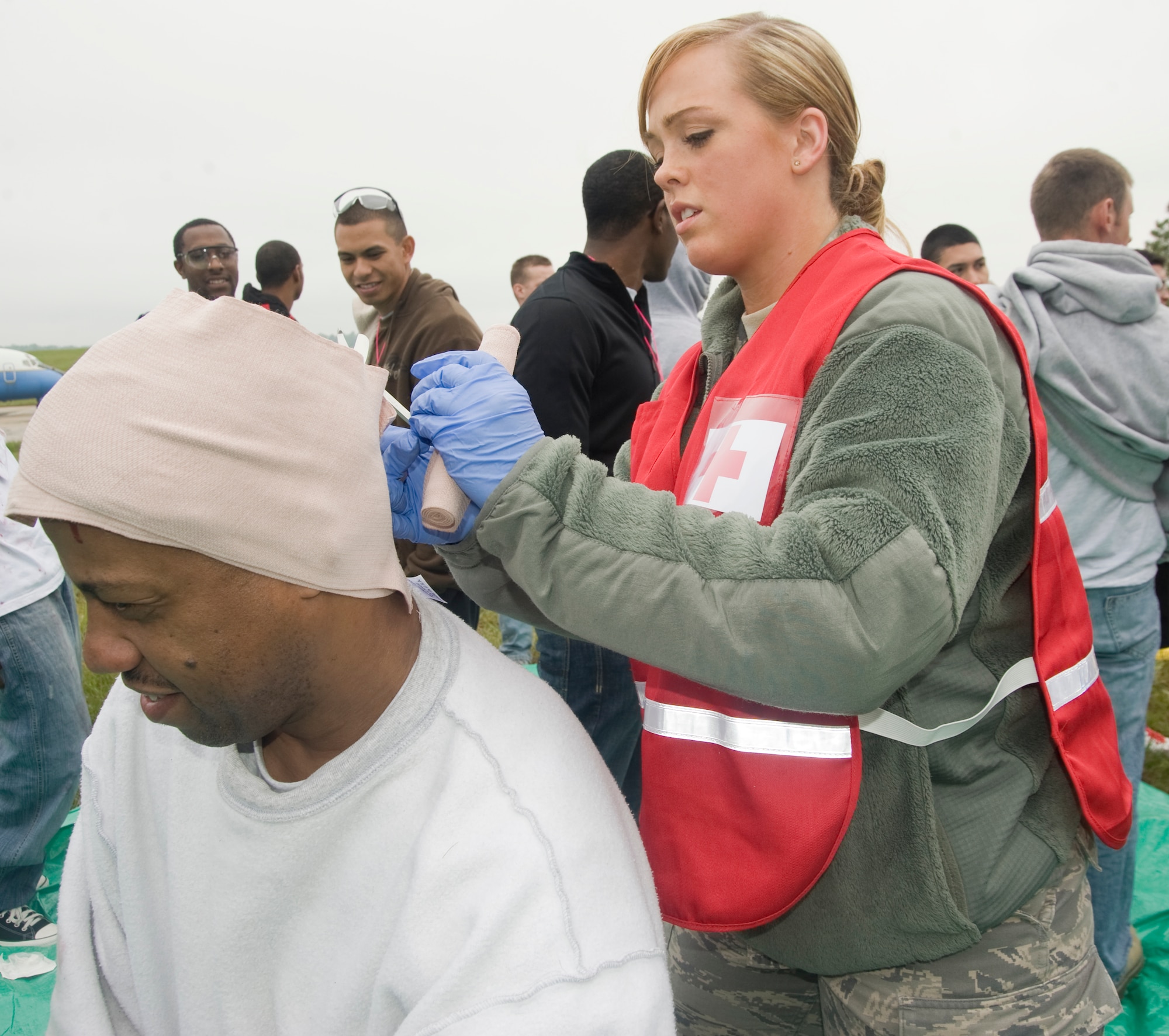 Airman 1st Class Rebecca Burns, 779th Aerospace Medicine Squadron aerospace medical technician, gives first aid to a simulated patient suffering from burns and lacerations prior to being evacuated during a mass casualty exercise on April 26.  (Photo/Bobby Jones)