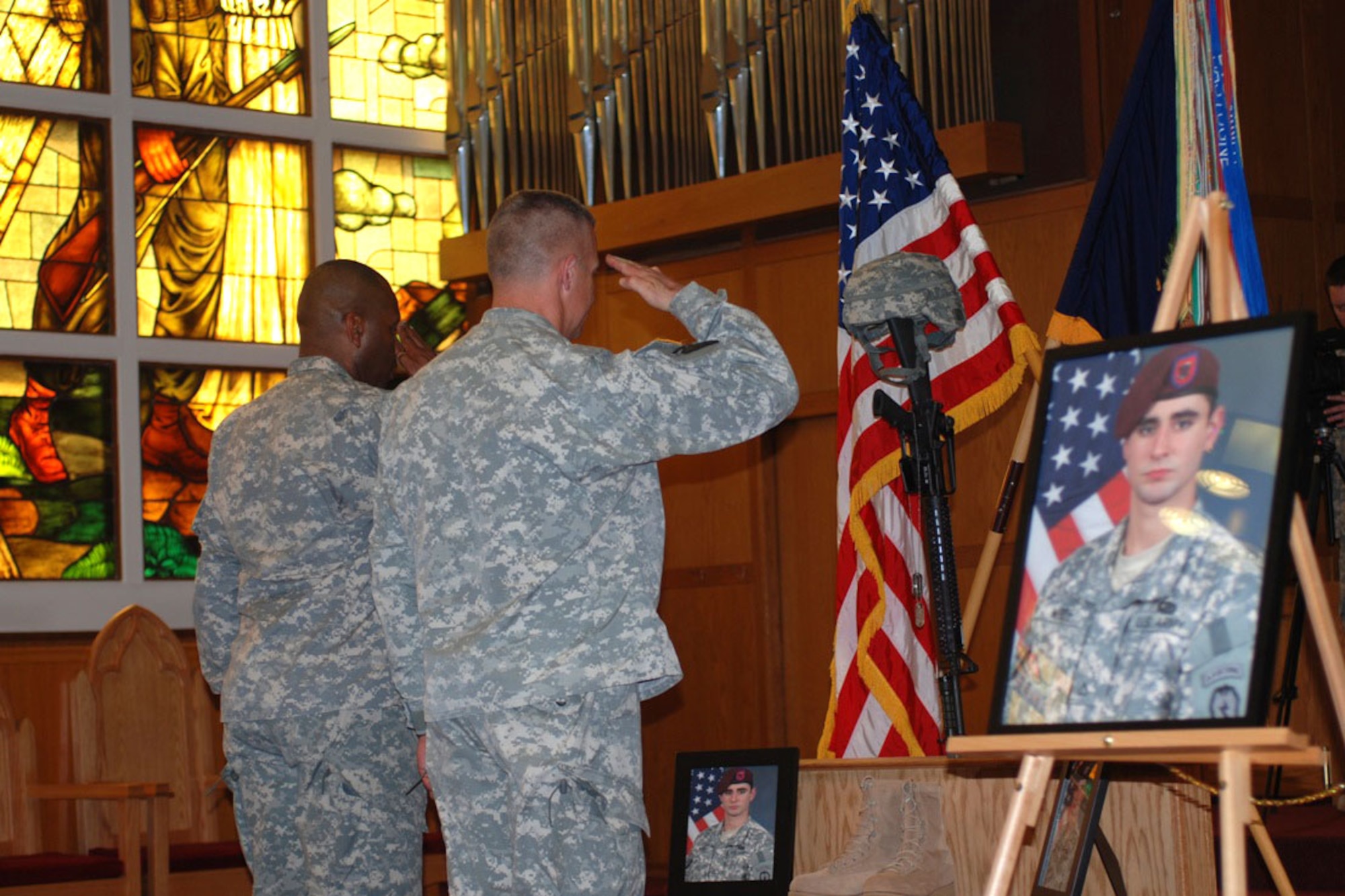 Soldiers attending an April 26 memorial for Spc. Jeffrey White  at JBER’s Soldiers’ Chapel pay their final respects for their fallen comrade in arms, Spc. Jeffrey White. (U.S. Army photo/Staff Sgt. Matthew E. Winstead)
