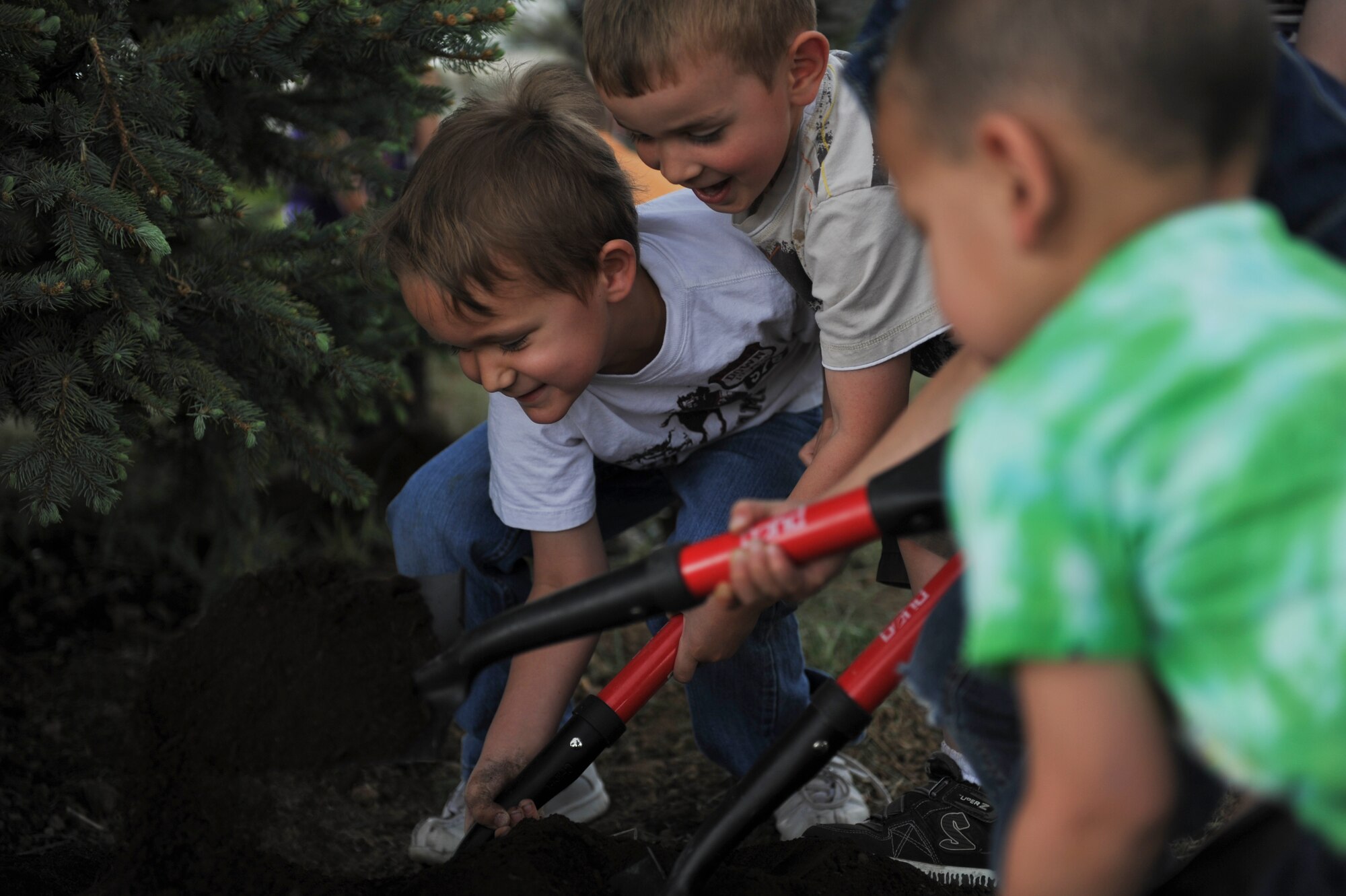 BUCKLEY AIR FORCE BASE, Colo. – Tristan Rowley, left, and Aaron Diggs, middle, from the Buckley Child Development Center plant and take care of trees, April 26, 2012. It was the lack of trees in Nebraska that led to the founding of Arbor Day in the 1800’s. (U.S. Air Force photo by Airman 1st Class Darryl Bolden Jr.)