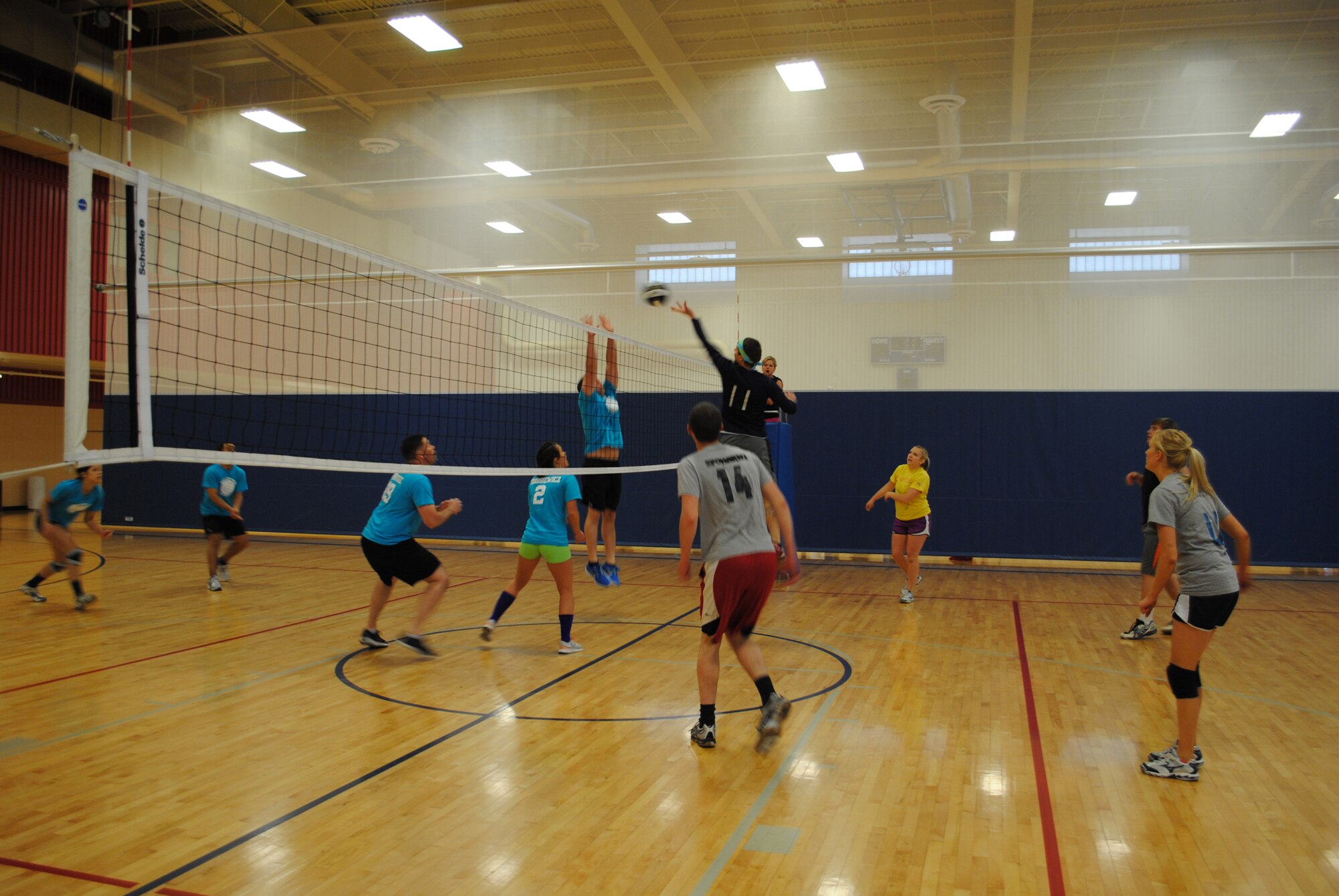 Members of the Dandy Lions team, right, prepare for defense as one of their players spikes the ball over to the opposing team. The Dandy Lions drove more than three hours from Missoula and ended up winning the tournament April 28. (U.S. Air Force photo/Airman 1st Class Cortney Paxton)