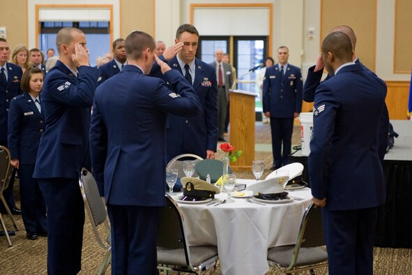 Members of the Airman Leadership School render a salute after the ceremony to honor missing service members at the start of the Retiree Appreciation Dinner April 28. (U.S. Air Force photo/Beau Wade)