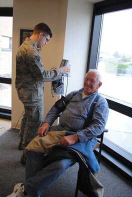 Airman 1st Class Zachary Kirby, 341st Medical Operations Squadron medical technician, performs a blood pressure examination on retiree Larry Hilzendeger at the clinic April 28. (U.S. Air Force photo/Airman 1st Class Katrina Heikkinen)