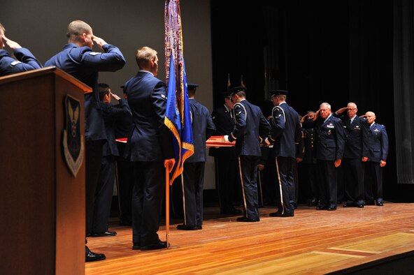 Members of both the active-duty Air Force, left, and retired members of all services, right, participated in the kick-off event for the annual Retiree's Appreciation Weekend April 27. A formal retreat ceremony was held at the base auditorium in their honor. (U.S. Air Force photo/John Turner)