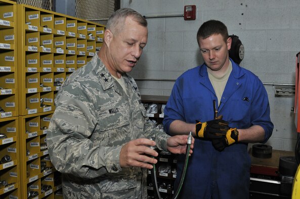 Maj. Gen. Lawrence Wells, 9th Air Force commander, looks over a piece of equipment in vehicle maintenance as Staff Sgt. Jacob Mayfield, 819th RED HORSE Squadron vehicle maintenance journeyman, explains its purpose and what it's used for. Wells toured many areas of Malmstrom Air Force Base during his visit April 30-May 2. (U.S. Air Force photo/John Turner)
