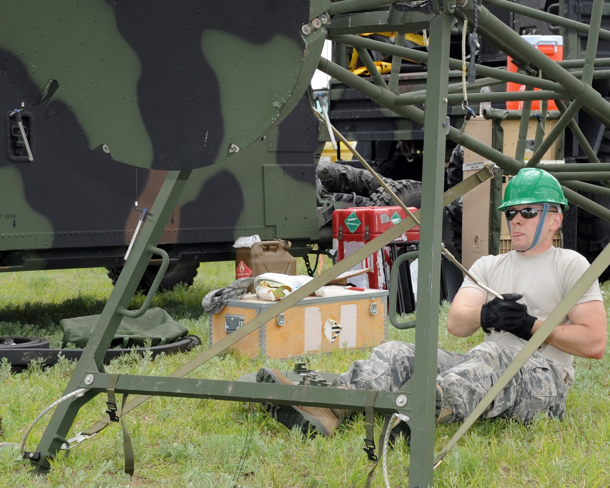 ALTUS AIR FORCE BASE, Okla. -- Airman 1st Class Andrew T. Hardcastle, 31st Combat Communication Squadron radio frequency transmission system apprentice, Tinker Air Force Base, Okla., uses a tool to position the dish portion of a Tropospheric Scatter Microwave Radio Terminal (TRC-170), May 1, 2012, during an exercise here. During the exercise Airmen from the 31st and 34th CCS assembled two TRC-170s, which transmitted a signal to Tinker AFB to test the range of the system. (U.S. Air Force photo by Airman 1st Class Kenneth W. Norman / Released / 97th Air Mobility Wing Public Affairs)