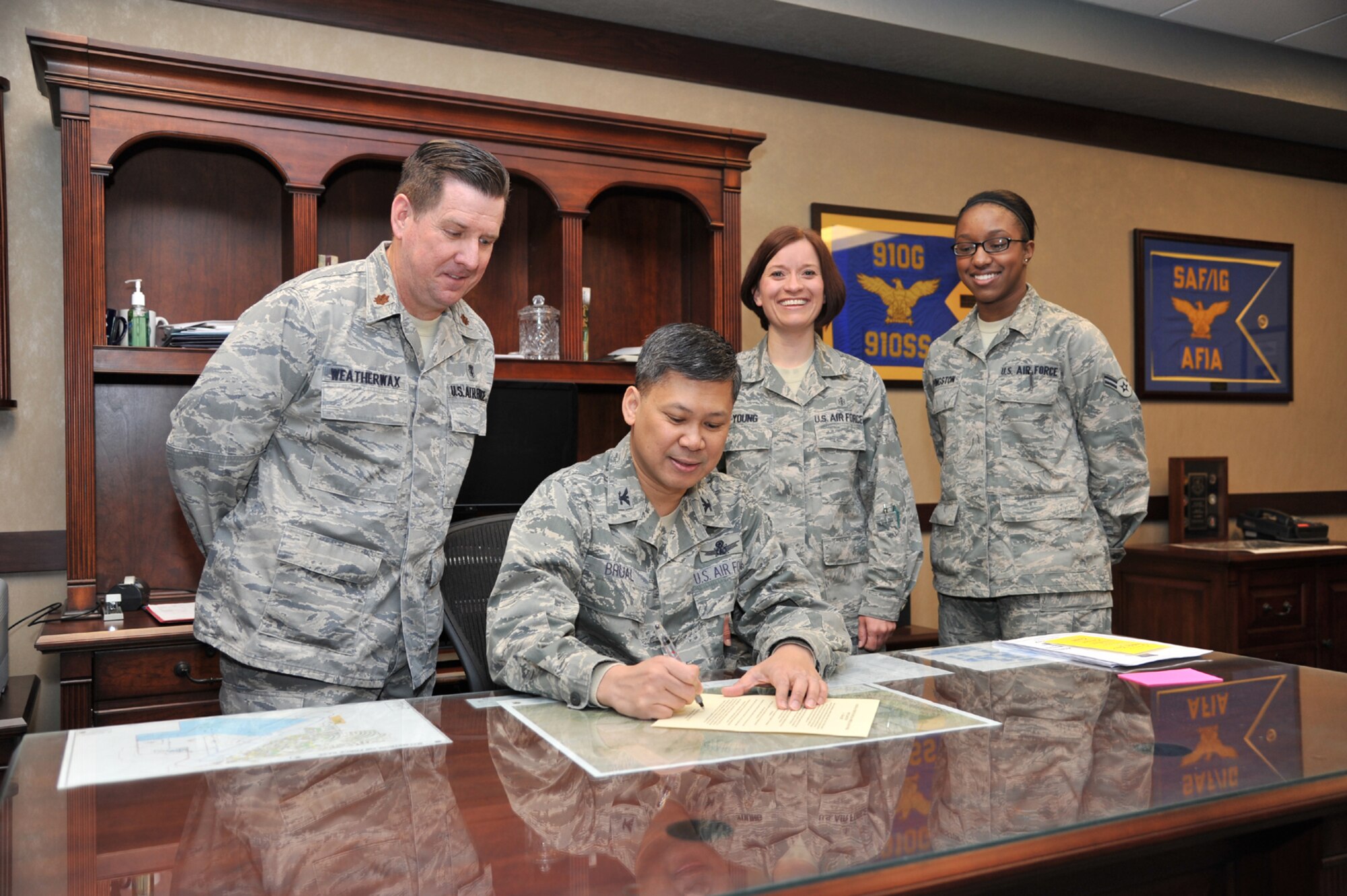 Members of the 341st Medical Operations Squadron, Maj. John Weatherwax, pedriatric nurse; and Staff Sgt. Katrina Young and Airman 1st Class Regina Livingston, both medical technicaisn; watch as Col. H.B. Brual, 341st Missile Wing commander, sings the Nurses and Technicians Appreciation Week Proclaimation on May 2. May 6 through May 12 is Nurses and Technicians Appreciation week this year, and is dedicated to the hard work of the nurses and medical technicians who strive to improve health care. (U.S. Air Force photo/John Turner)