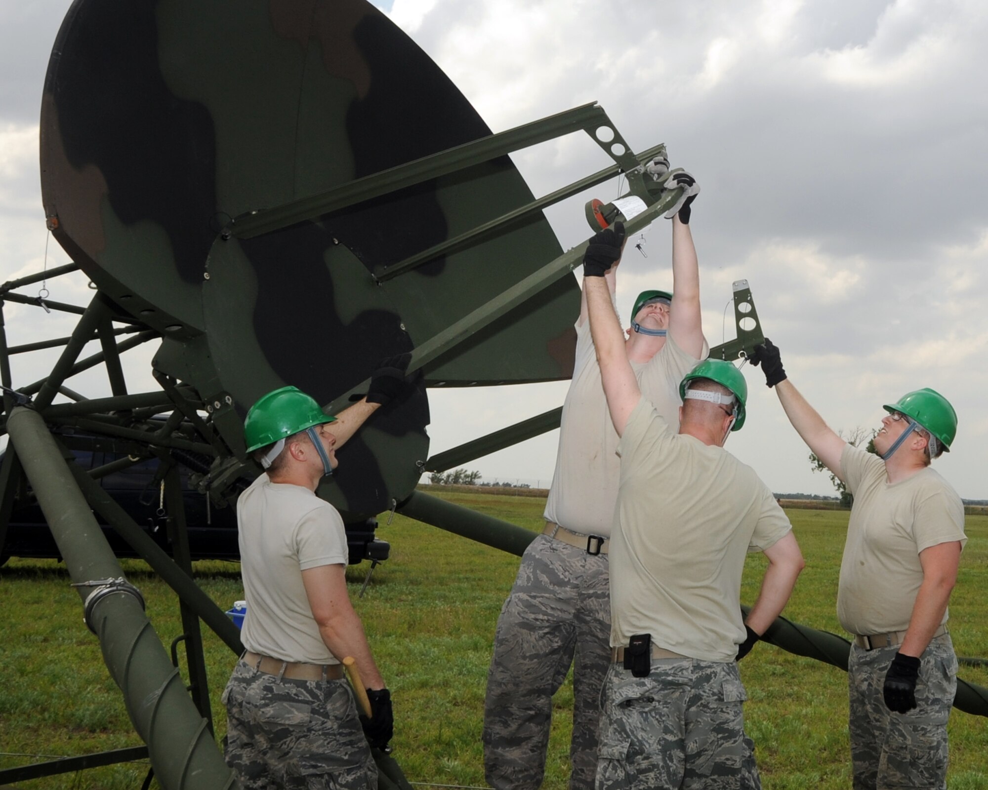 ALTUS AIR FORCE BASE, Okla. – Airmen from the 31st Combat Communication Squadron, Tinker Air Force Base, Okla., assemble a Tropospheric Scatter Microwave Radio Terminal (TRC-170), April 30, 2012, during an exercise here. During the exercise Airmen from the 31st and 34th CCS assembled two TRC-170s, which transmitted a signal to Tinker AFB to test the range of the system. (U.S. Air Force photo by Airman 1st Class Kenneth W. Norman / Released / 97th Air Mobility Wing Public Affairs)
