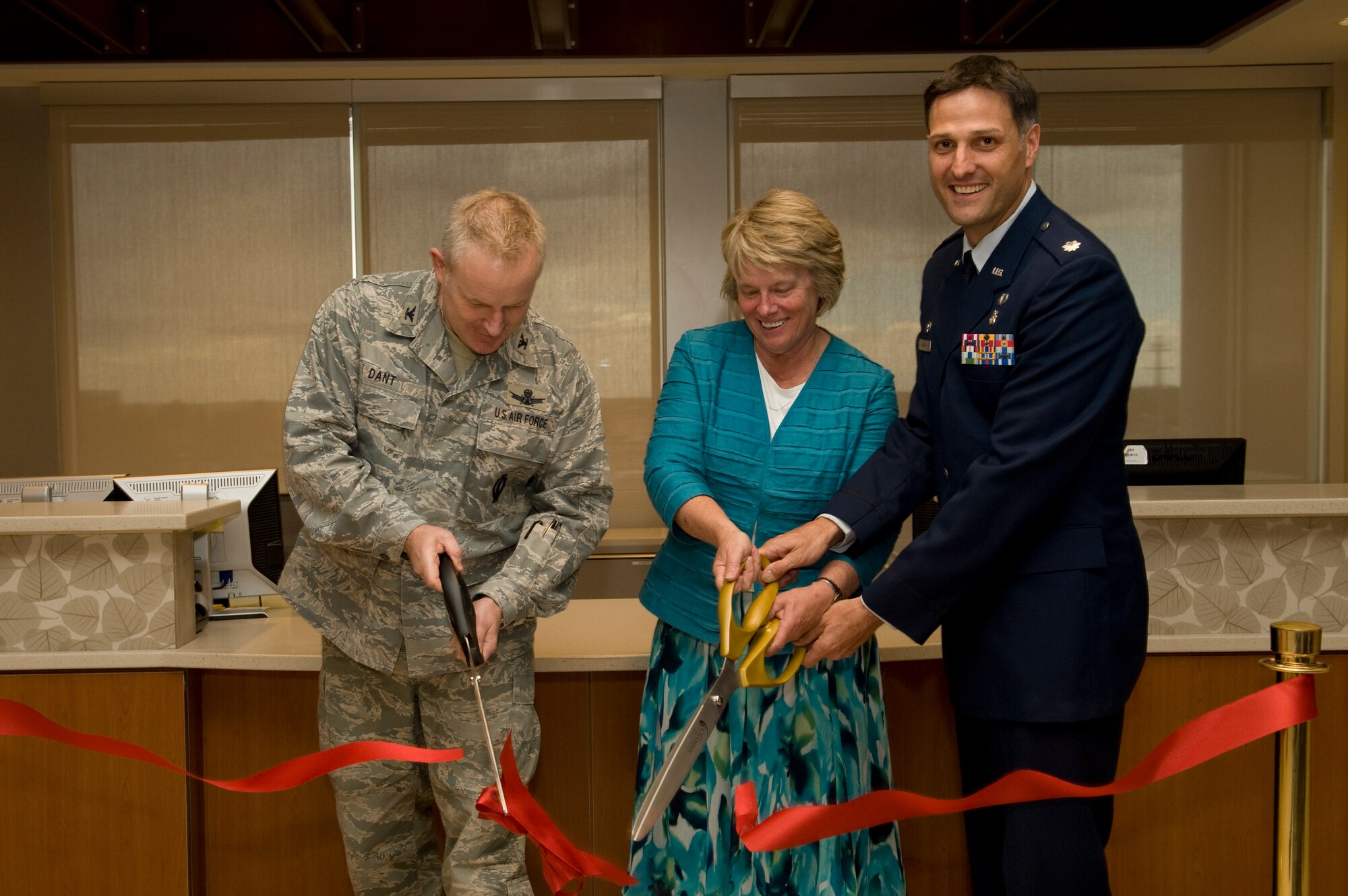 BUCKLEY AIR FORCE BASE, Colo. --   From left to right, Col. Daniel Dant, 460th Space Wing commander, Lynette A. Roff, Director of Veteran Affairs Eastern Colorado Health Care System, and Lt. Col. Scot Spann, 460th Medical Group deputy commander, cut the ribbon signifying the opening of the new Buckley Clinic, April 26, 2012.  The clinic was built as a collaboration between Buckley AFB and the VA, saving Buckley more than $150,000 a year. (U.S. Air Force photo by Airman 1st Class Phillip Houk)