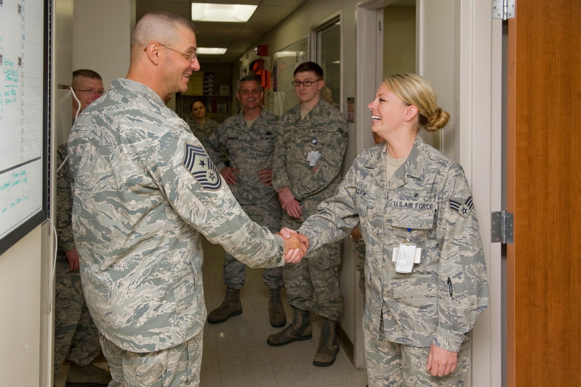 Chief Master Sgt. David Nordell, 20th Air Force command chief, greets Senior Airman Leslie Balliew, medical laboratory technician, during his tour of the 341st Medical Group April 26. Looking on are Senior Airman Sean GLeason, laboratory technician; Chief Master Sgt. Chuck Anderson, 341st Missile Wing command chief; Senior Master Sgt. Ron Beadies, 341st MDG senior enlisted advisor; and Master Sgt. Cynthia Boots, TOPA flight chief. (U.S. Air Force photo/Beau Wade)