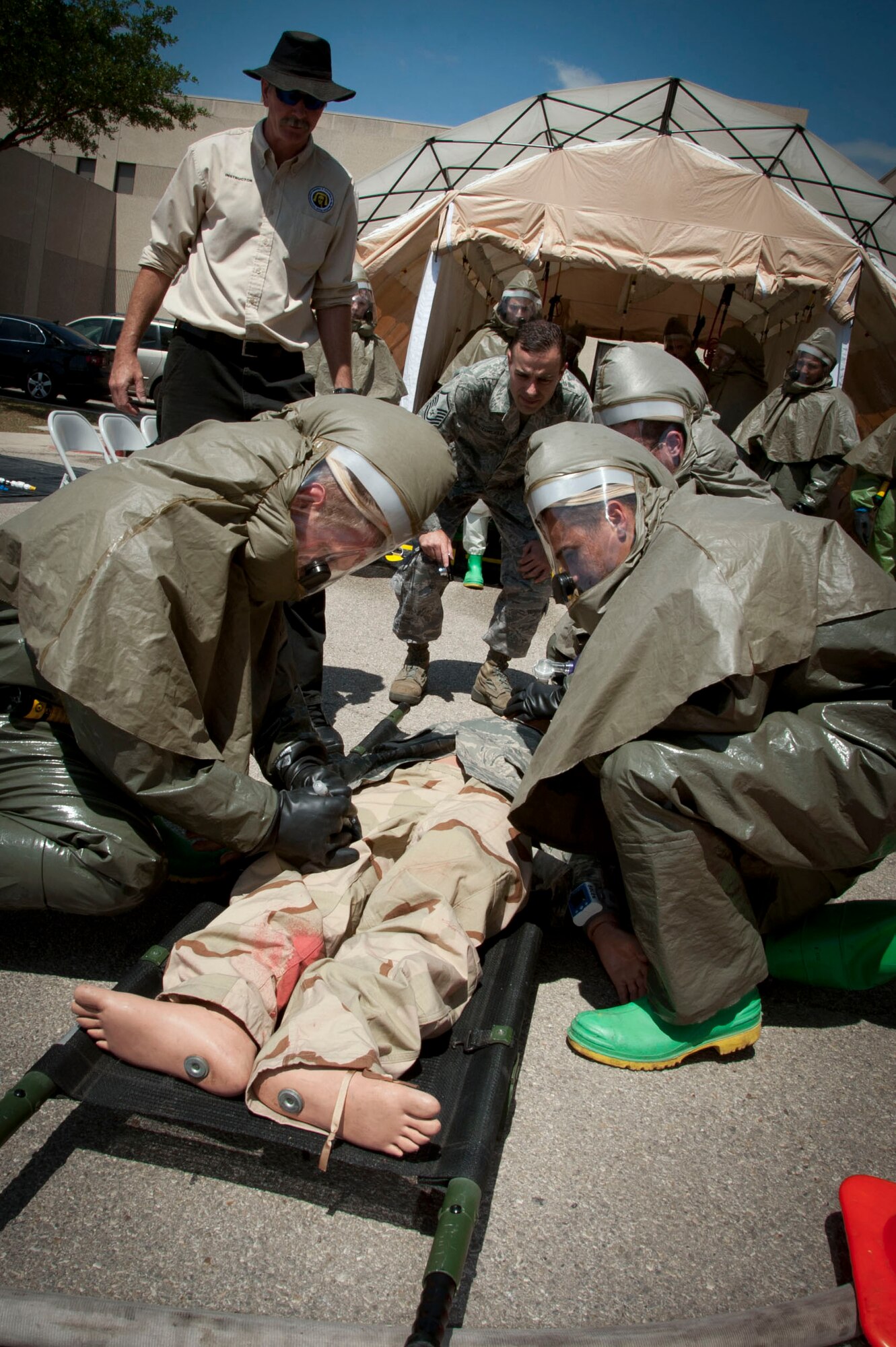 The 59th Medical Wing patient decontamination team prepare to move a simulated patient during an emergency management exercise April 19 at Lackland Air Force Base, Texas. The team must set up and be ready to decontaminate patients within 20 minutes of activation in order to receive a passing rate.  It took only 6 minutes to do the job, far exceeding the standard.  (U.S. Air Force photo/Senior Airman Corey Hook)