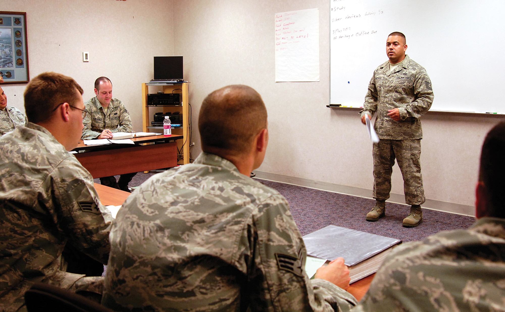Tech. Sgt. David Santiago is an Airman Leadership School instructor who is close to graduating with a Community College of the Air Force degree, a personal goal and a job requirement he wishes he’d accomplished years ago.   “The Air Force sets us up for an excellent road to success,” he said. “But we often just choose not to take advantage of it.” Deployments, family responsibilities and no ready access to computers were some reasons he delayed  his education.  Now the soon-to-be graduate and is taking his life-lessons learned into his ALS classroom where he pushes the importance of continuing education to his Airmen students. (Air Force photo by Margo Wright)