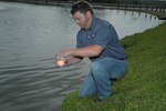 Bryan Harvey, 902nd Civil Engineer Squadron water quality program manager, collects a water test sample on JBSA-Randolph April 27. (U.S. Air Force photo by Airman 1st Class Alexis Siekert)