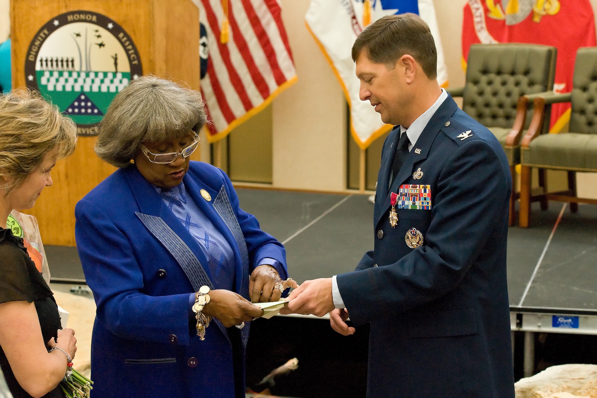 Col. Thomas. C Joyce thanks Virgina Carson, wife of the late Charles C. Carson, for her support during his tenure as commander of Air Force Mortuary Affairs Operations. Joyce relinquished command to Col. John M. Devillier during a change of command ceremony May 2, 2012 at the Charles C. Carson Center for Mortuary Affairs, Dover Air Force Base, Del. (U.S. Air Force photo/Roland Balik)