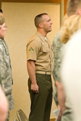 Marine Lance Cpl. Landon Beaty, a Marine liaison at the Charles C. Carson Center for Mortuary Affairs, sings the National Anthem at the Air Force Mortuary Affairs Operations Change of Command ceremony May 2, 2012 at Dover Air Force Base, Del. Col. Thomas Joyce relinquished command to Col. John Devillier. Lt. Gen. Darrell Jones, Deputy Chief of Staff, Manpower, Personnel and Services, officiated the ceremony. (U.S. Air Force photo/Roland Balik)
