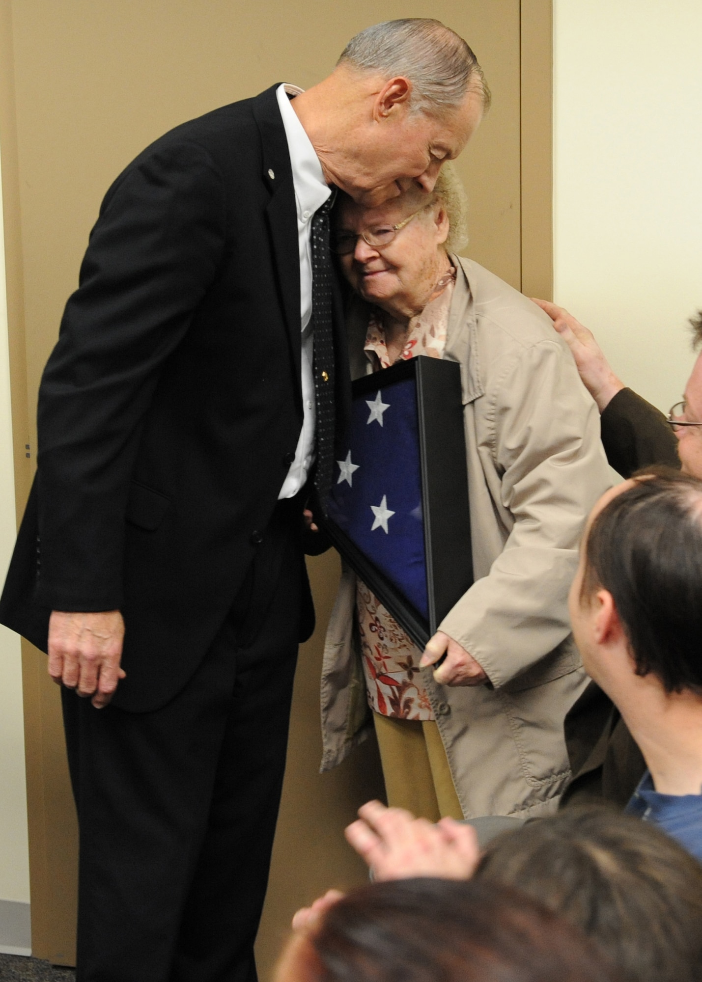 Chet Burress, 7th Space Warning Squadron ground radar systems analyst, gives a flag to his mother, Eula, during a ceremony April 26 at Beale Air Force Base, Calif. Burress was presented the flag by Rep. Wally Herger (R-Calif.) and gifted it to his mother thanking her for continued support and sacrifice. (U.S. Air Force photo by Mr. John Schwab)