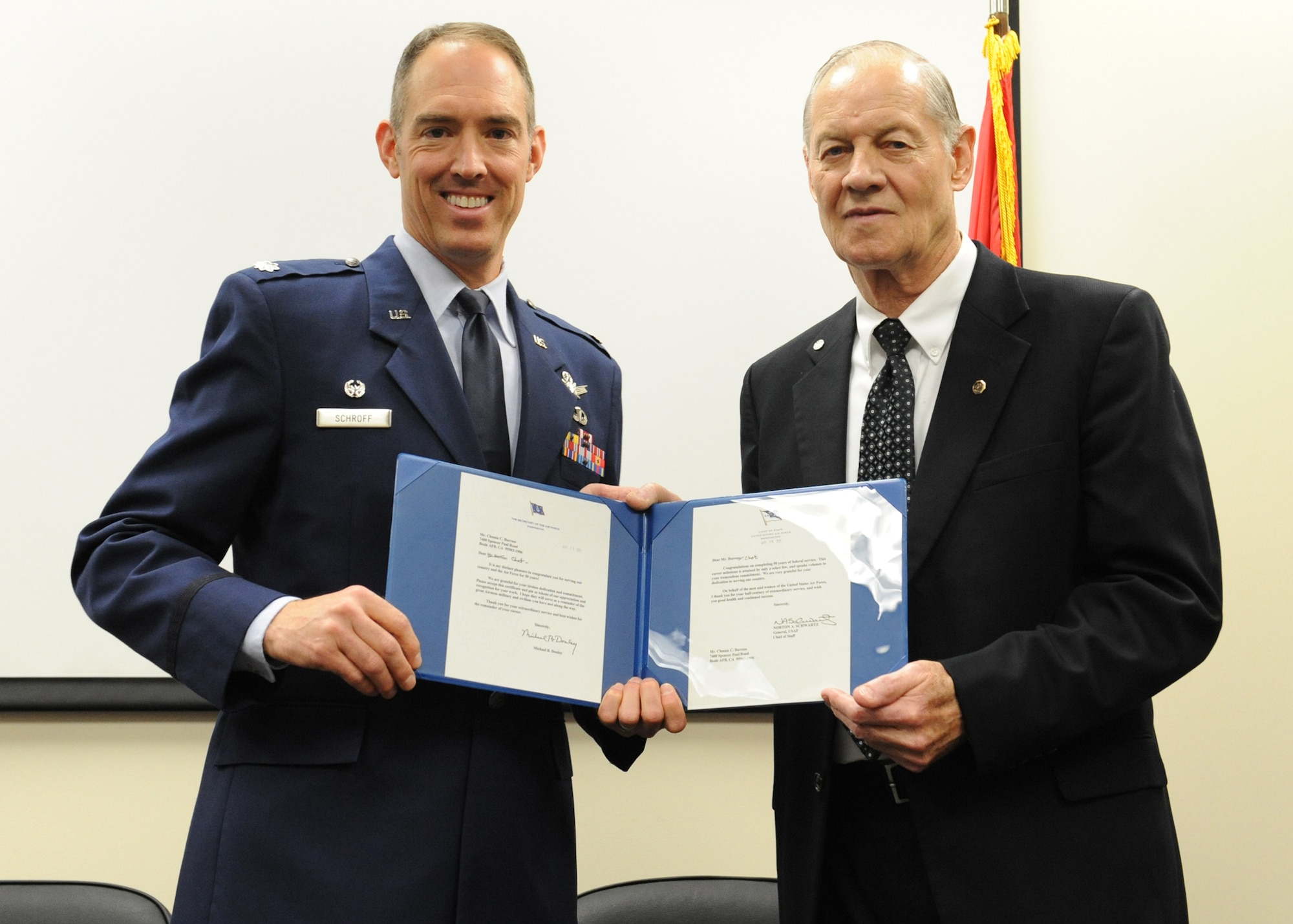 Lt. Col. Scott Schroff, 7th Space Warning Squadron commander, presents Chet Burress, 7th SWS ground radar systems analyst, letters from the Chief of Staff of the Air Force, Gen. Norton A. Schwartz and Chief Master Sgt. of the Air Force James A. Roy at a ceremony April 26 at Beale Air Force Base, Calif. Burress received numerous awards for his 50 years of federal service. (U.S. Air Force photo by Mr. John Schwab)