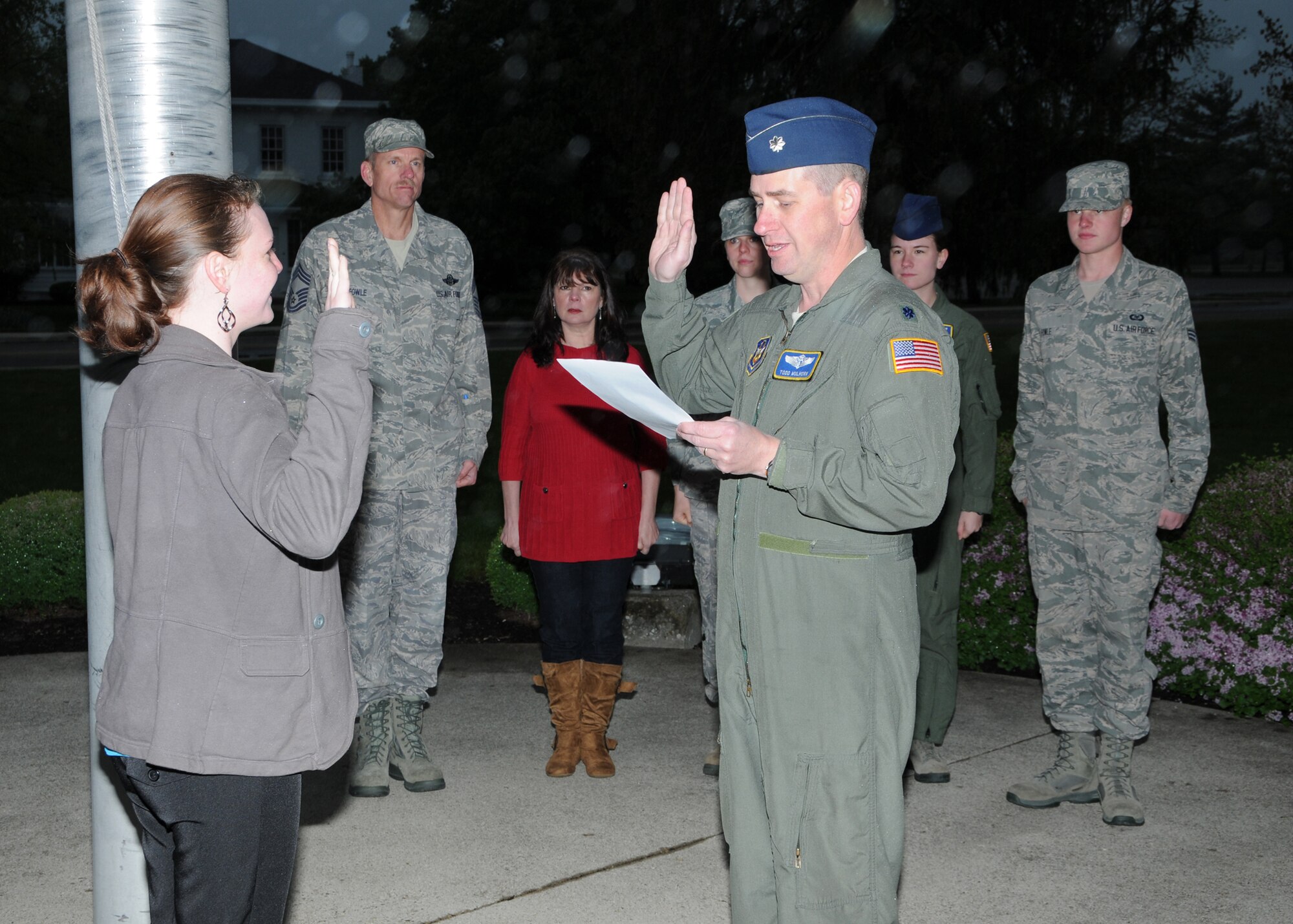 WRIGHT-PATTERSON AIR FORCE BASE, Ohio – Lt. Col. Todd Mulhorn, 445th Aeromedical Squadron, operations officer, administers the oath of enlistment to Airman 1st Class Bethany Fowle April 21 as her family looks on. Before joining the Air Force Reserve, Fowle served on active duty for 2 1/2 years at both Nellis Air Force Base and Creech Air Force Base in Nevada before separating in June 2011. She will be assigned to the 445th Aircraft Maintenance Squadron. (U.S. Air Force photo/Tech. Sgt. Anthony Springer)