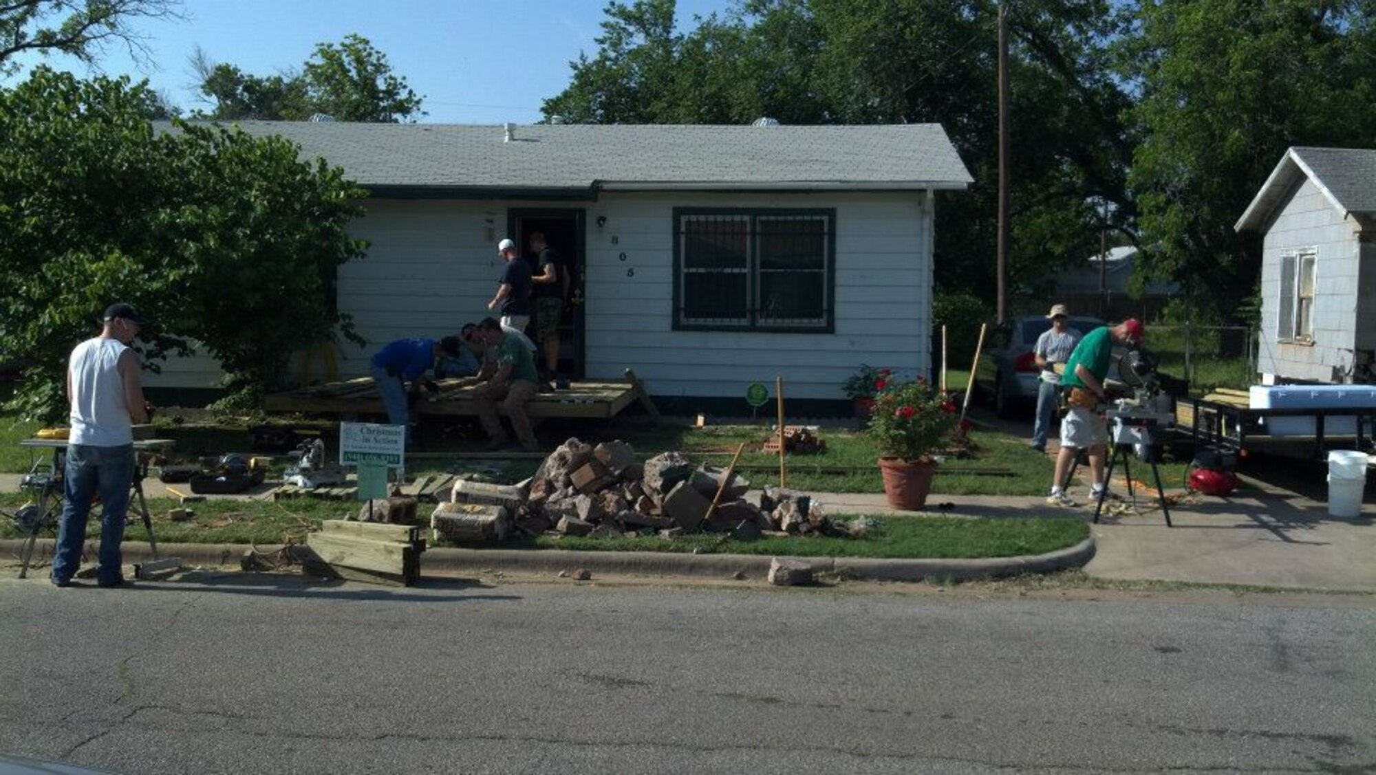 A team of volunteers from the 363rd Training Squadron at Sheppard Air Force Base build a new porch and ramp as part of the Christmas in Action community program designed to help the elderly and disabled in Wichita county, Texas April 28, 2012. The nuclear weapons training instructors have volunteered for three years to support the event. Christmas in Action budgeted $95,000 for 53 home improvement projects in 2012. Sheppard AFB volunteers made up 25 of the 53 teams to renovate homes. (U.S. Air Force Photo/Jason Thompson)