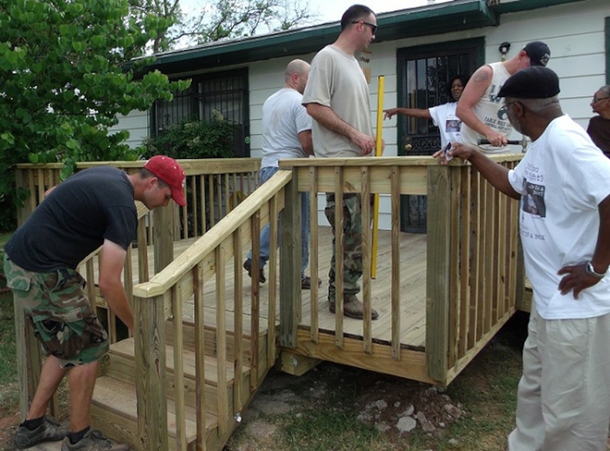 Sheppard Air Force Base volunteers took on 25 homes during 2012 Christmas in Action, assisting the elderly and disabled in the Wichita Falls area April 28, 2012. Armed with a $700 budget, 17 volunteers and a lot of heart, the 363rd Training Squadron volunteer team built a porch, deck and ramp for one homeowner, saving her an estimated $5,100. The program, celebrating its 29th year, renovated 53 homes with a $95,000 budget in Wichita Falls and Burkburnett, Texas over the weekend. (U.S. Air Force photo/Debi Smith)