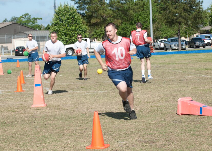 Airmen participate in a game called Icarus, which is a combination of dodge-ball and Quiddich and one of the many games held for the 23d Maintenance Group Sports Day event April 27, 2012, at Moody Air Force Base, Ga. The MXG members competed in different sports earning them points for each win. After a pig roast and a game of Tug of War, the sports day was concluded with the presentation of the trophy to the squadron with the most winning points. (U.S. Air Force photo by Senior Airman Eileen Meier/Released)