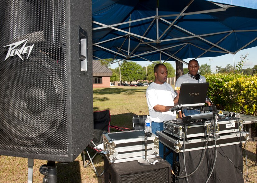 U.S. Air Force Master Sgt. Nathan Hill and Airman 1st Class Julian Wright, 23d Component Maintenance Squadron, serve as disc jockeys at the 23d Maintenance Group Sports Day event held to enhance Airmen morale April 27, 2012, at Moody Air Force Base, Ga. A pig roast along with the presentation of a trophy given to the squadron that gained the most points from all of the different sports concluded the days events. (U.S. Air Force photo by Senior Airman Eileen Meier/Released)