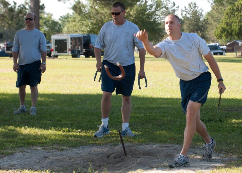 Airmen with the 23d Maintenance Group participate in a game of horseshoes during the MXG Sports Day event April 27, 2012, at Moody Air Force Base, Ga. The event included various sports, a pig roast, music throughout the day from a disc jockey and concluded with a trophy presentation to the squadron with the most winning points. (U.S. Air Force photo by Senior Airman Eileen Meier/Released)